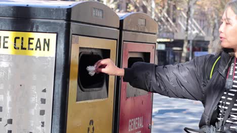 individual throws trash into bin in melbourne