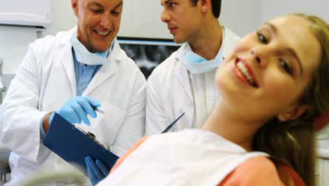 portrait of smiling female patient sitting on dental chair