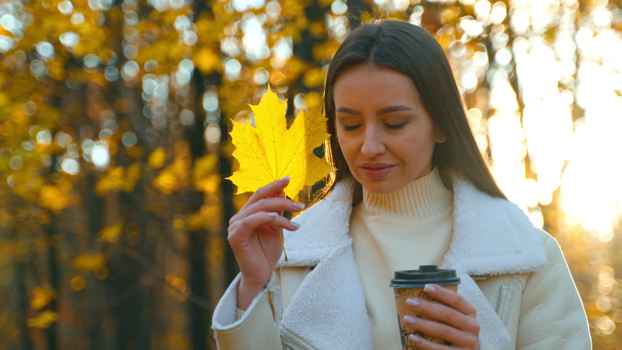 Woman enjoying coffee in an autumn park