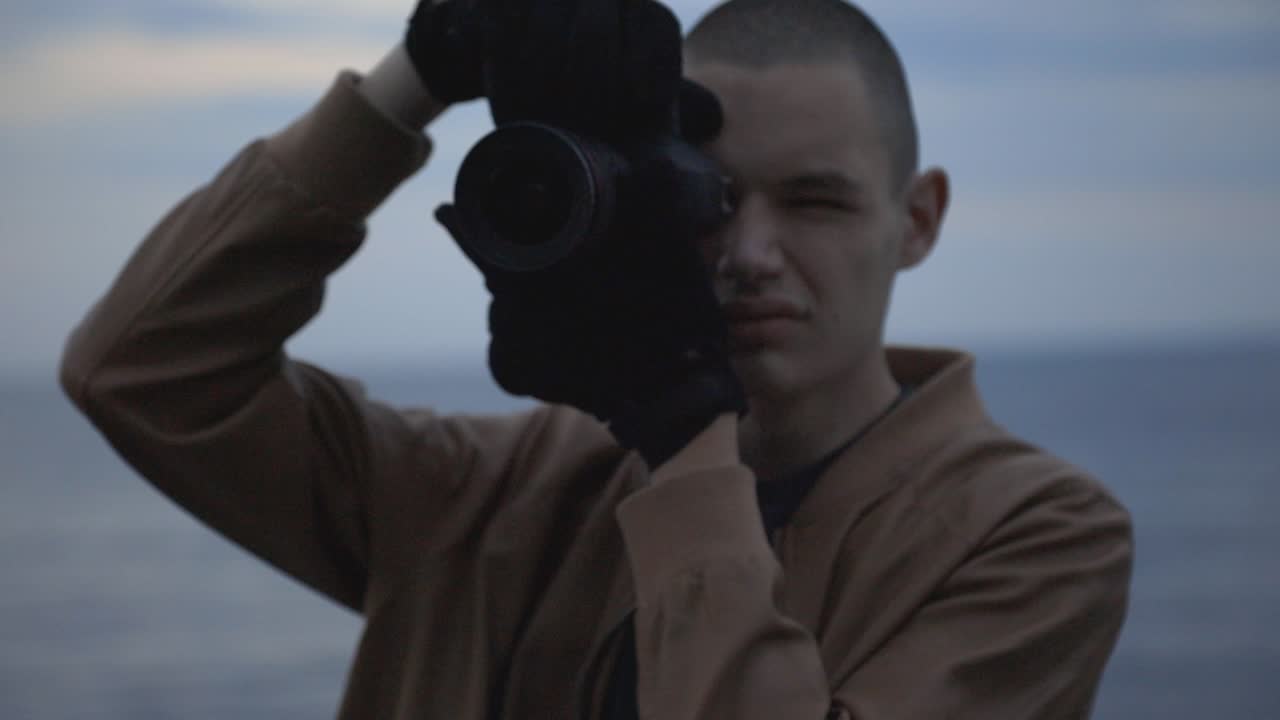 Caucasian Man Taking Photos Of Nature In The Early Evening - close up