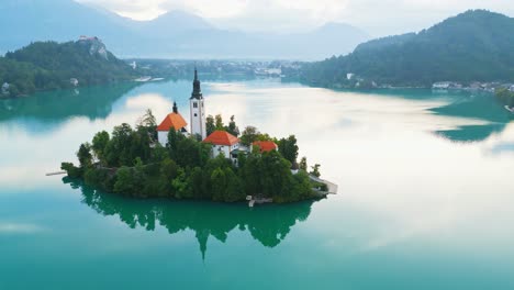 lake bled reflecting objects and orbit of church island in slovenia