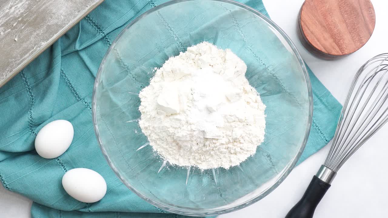 Making a dessert called Red Raspberry Tea Cake made with fresh berries and vanilla buttercream frosting. Great for Tea Parties. Whisking together the dry ingredients for the vanilla cake batter