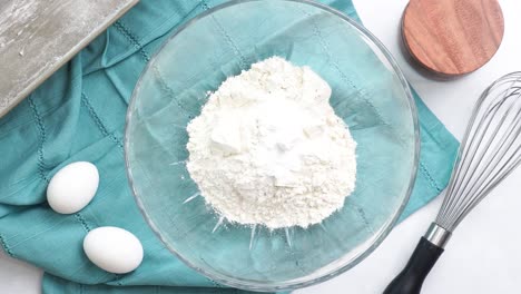 making a dessert called red raspberry tea cake made with fresh berries and vanilla buttercream frosting. great for tea parties. whisking together the dry ingredients for the vanilla cake batter