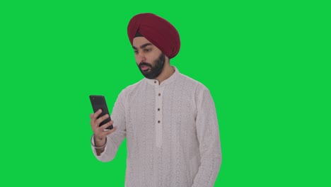 angry sikh indian man shouting on video call green screen