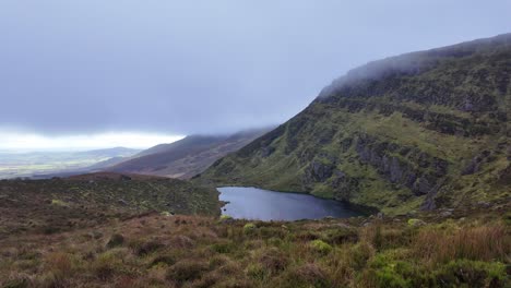 Mountainside-Lough-Coumdala-in-The-Comeragh-Mountains-on-a-November-day-hillwalking-in-winter
