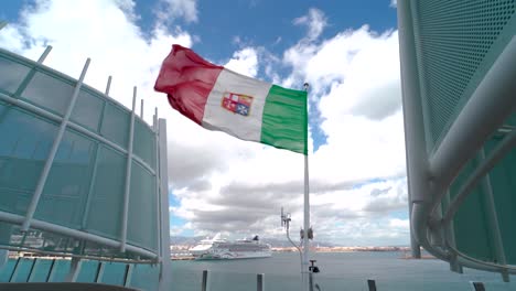 Flag-of-Italy-waving-at-the-stern-of-a-sailing-cruise-ship