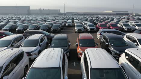 large lot of cars at manufacturing facility
