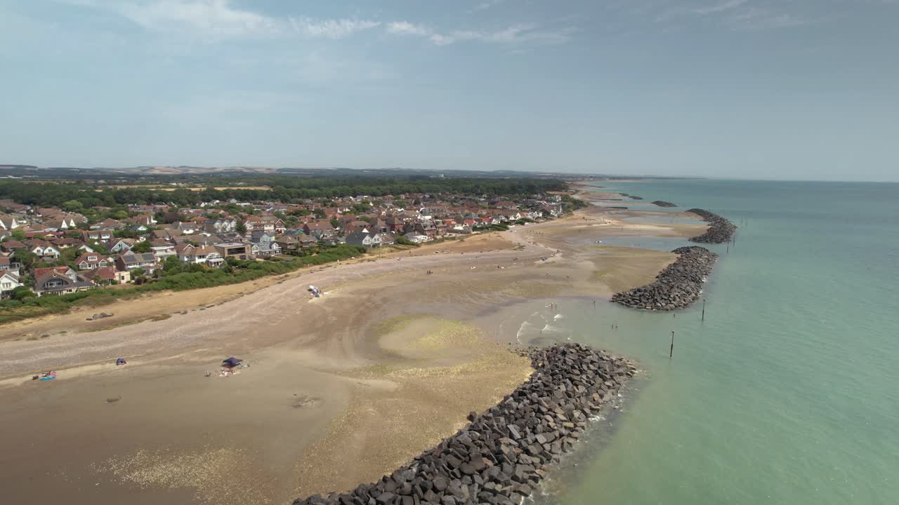 People on Holiday Enjoying Sandy Beach in West