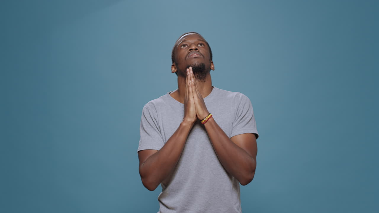 Male model holding hands in prayer to do spiritual session