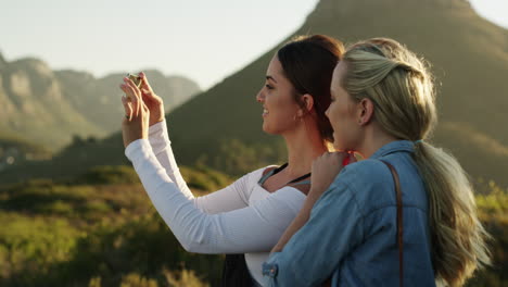 two female best friends taking a picture in nature