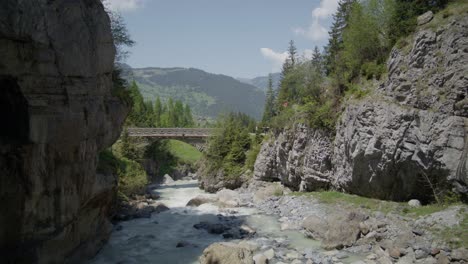 water rapids at caveside opening near bridge | grindelwald switzerland cave in glacier canyon, europe, 4k