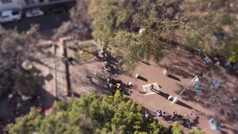 a dynamic aerial shot of dancing partners performing tango within the public park