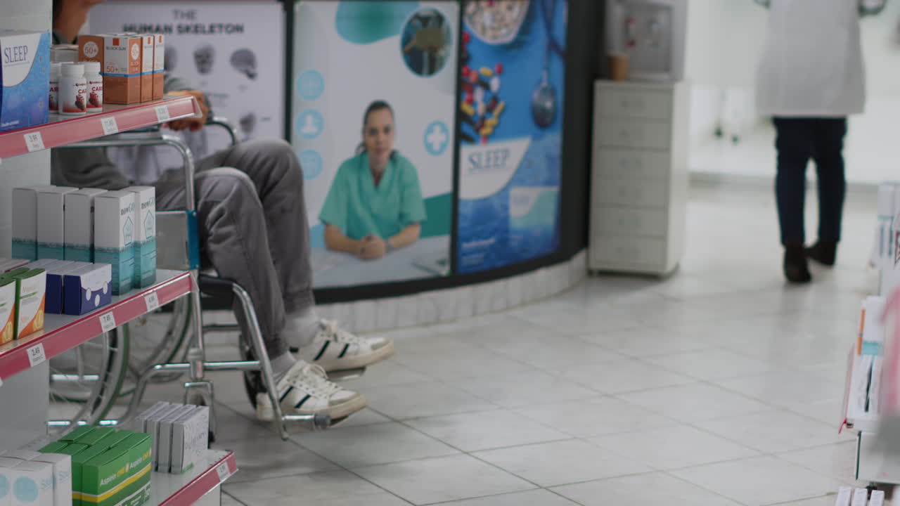 Patient in Wheelchair at Pharmacy with Healthcare Professionals
