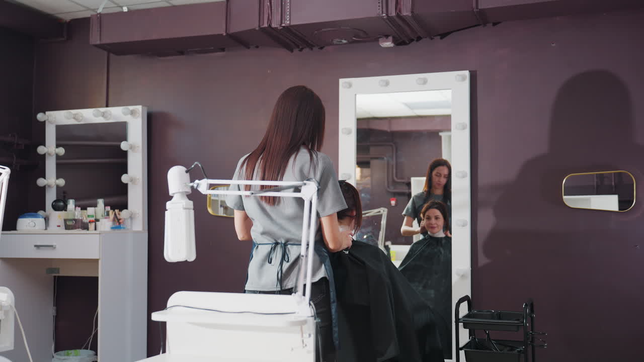 hairdresser and patron reflection scene, salon interior with stylist and customer interaction, caucasian hair professional and client captured in mirror before service begins in salon