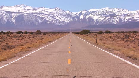 a long straight lonely road heads to the mountains