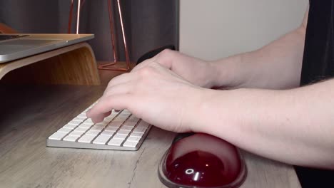 Man using a computer keyboard support for typing preventing repetitive strain injury