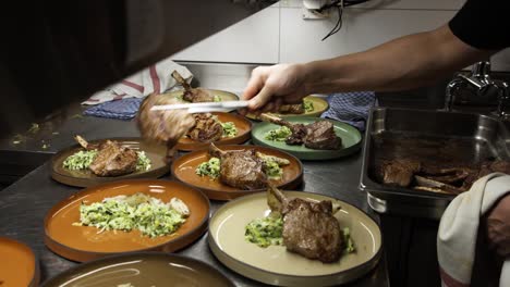 slow motion preparation of tomahawk steaks by a professional chef in a restaurant kitchen