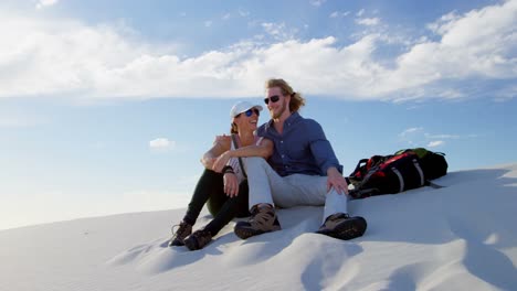 couple sitting and talking in the desert 4k