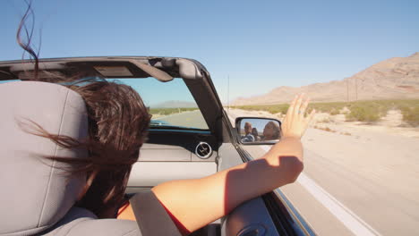 couple on road trip driving in convertible car shot on r3d