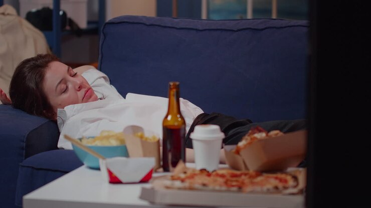 Young adult feeling sleepy while watching television