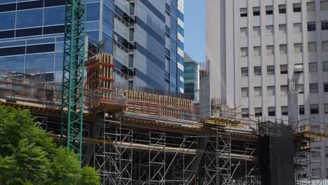 a construction site with a crane and steel framework in the city, showcasing urban development