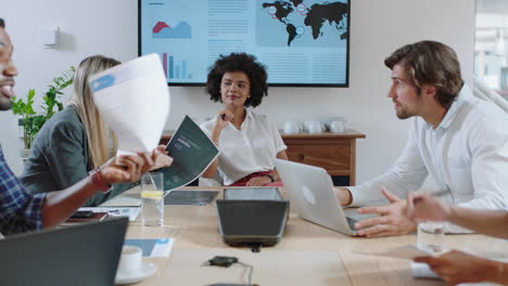 young mixed race business woman executive meeting with collegues discussing development ideas with brainstorming in busy office boardroom