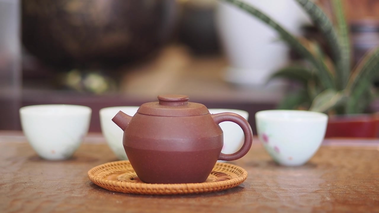 Traditional Clay Teapot and Tea Cups on a Wooden Tray