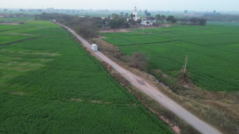 vehicle-moving-front-in-crop-fields-wide-side-view