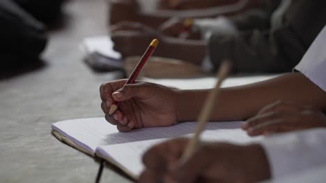 muslim arabic african kids at school writing in her notebook