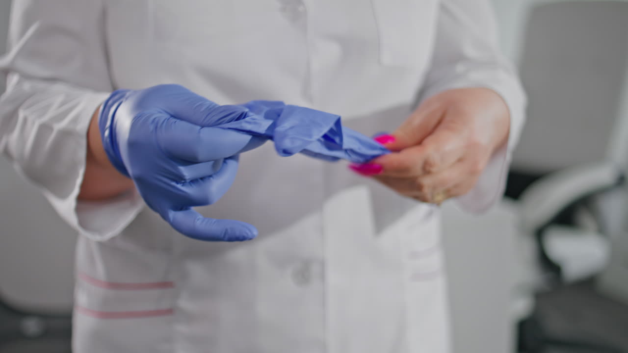 Medic putting protective gloves preparing for healthcare procedures closeup