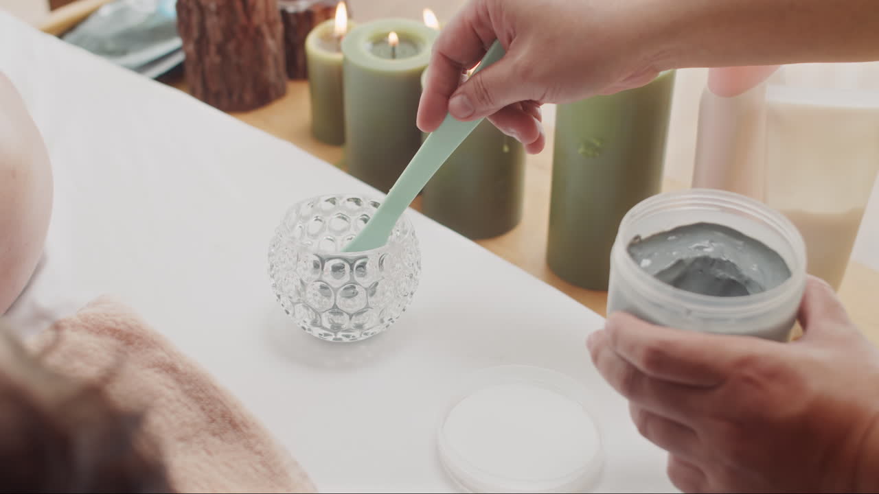 Female Hands Preparing Cosmetic Clay for Applying