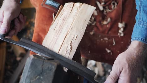 woodworker carving block on wooden lathe