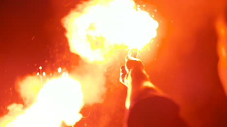 close up of a burning signal flare held by a man 2