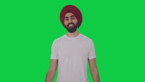 happy sikh indian man lifting heavy dumbbells green screen