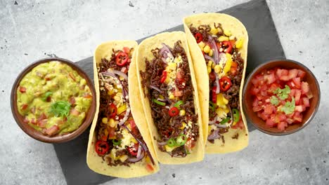 tasty mexican meat tacos served with various vegetables and salsa