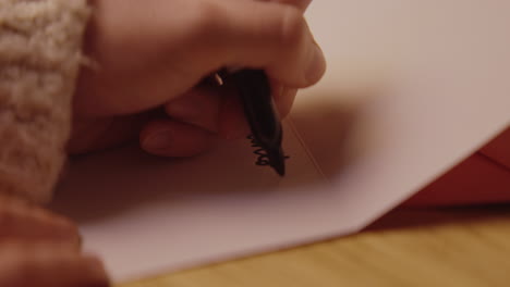 person writing a letter