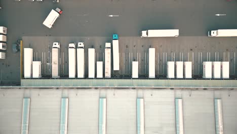 warehouses, huge logistics center near the highway, view of a large number of cargo trailers and containers, international cargo transportation, aerial view