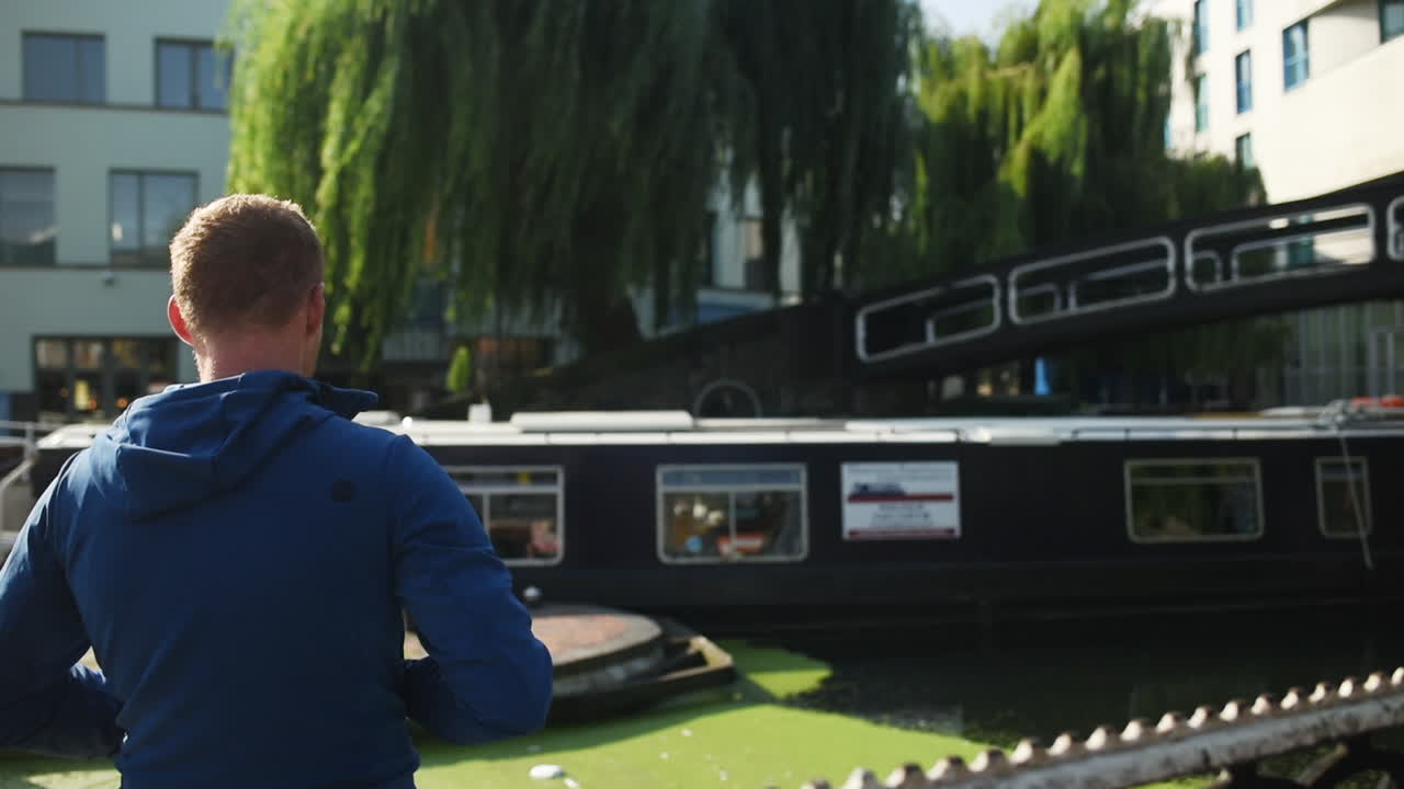 Man Waving On The People Riding A Cruising Boat On The River In London, UK - medium slowmo shot