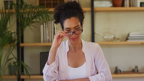 Caucasian-woman-talking-to-camera-on-video-call,-working-from-home