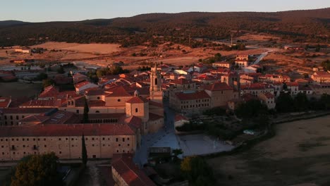 vista aérea de un monasterio y la ciudad a la que pertenece al atardecer