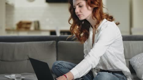 Concentrated-woman-working-home-in-day-time.-Pretty-girl-checking-paper.