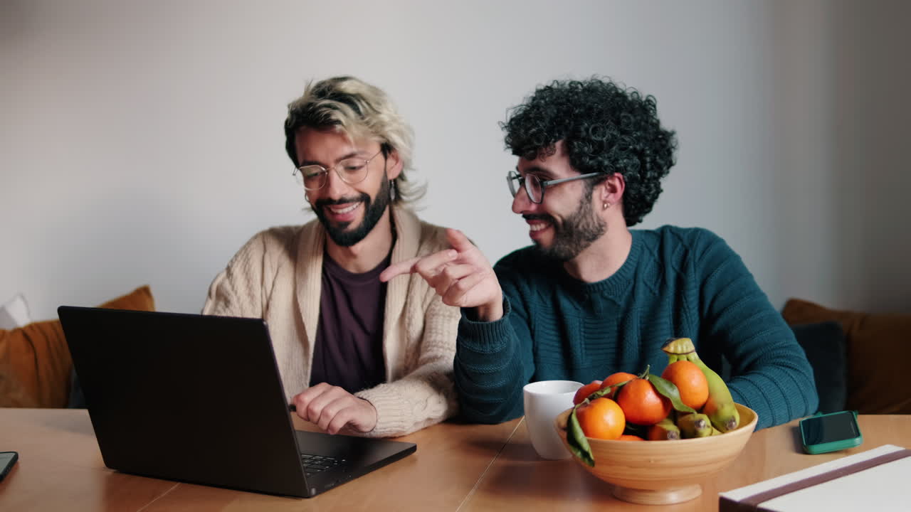 Gay Couple Working From Home on Laptop