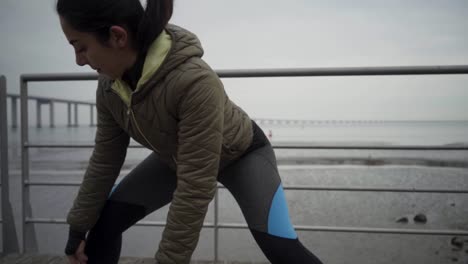 focused hindu sportswoman warming up before workout