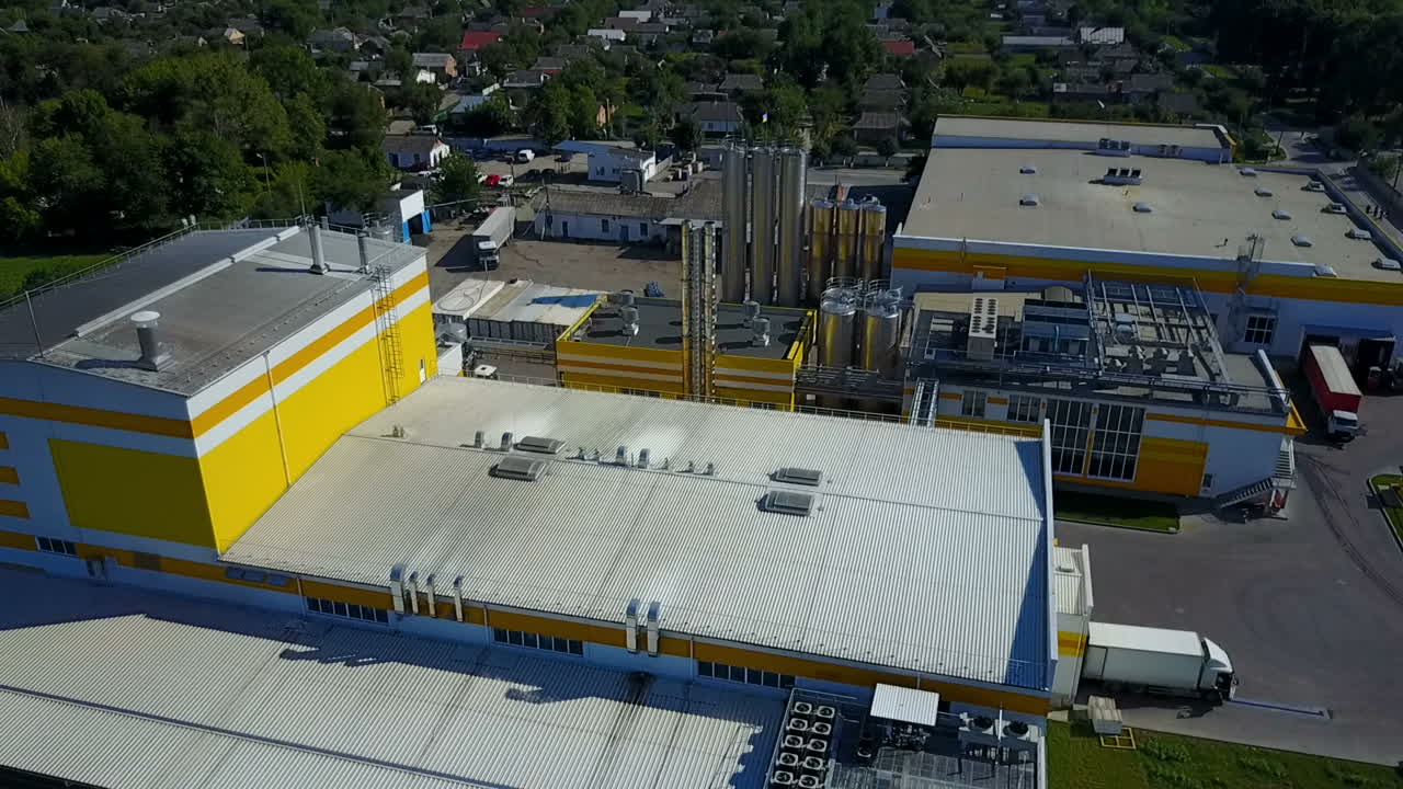 Industrial Area With Factory. LADUJUN, UKRAINE - JUNE 2017: Aerial view of a factory or industrial area surrounded by green fields