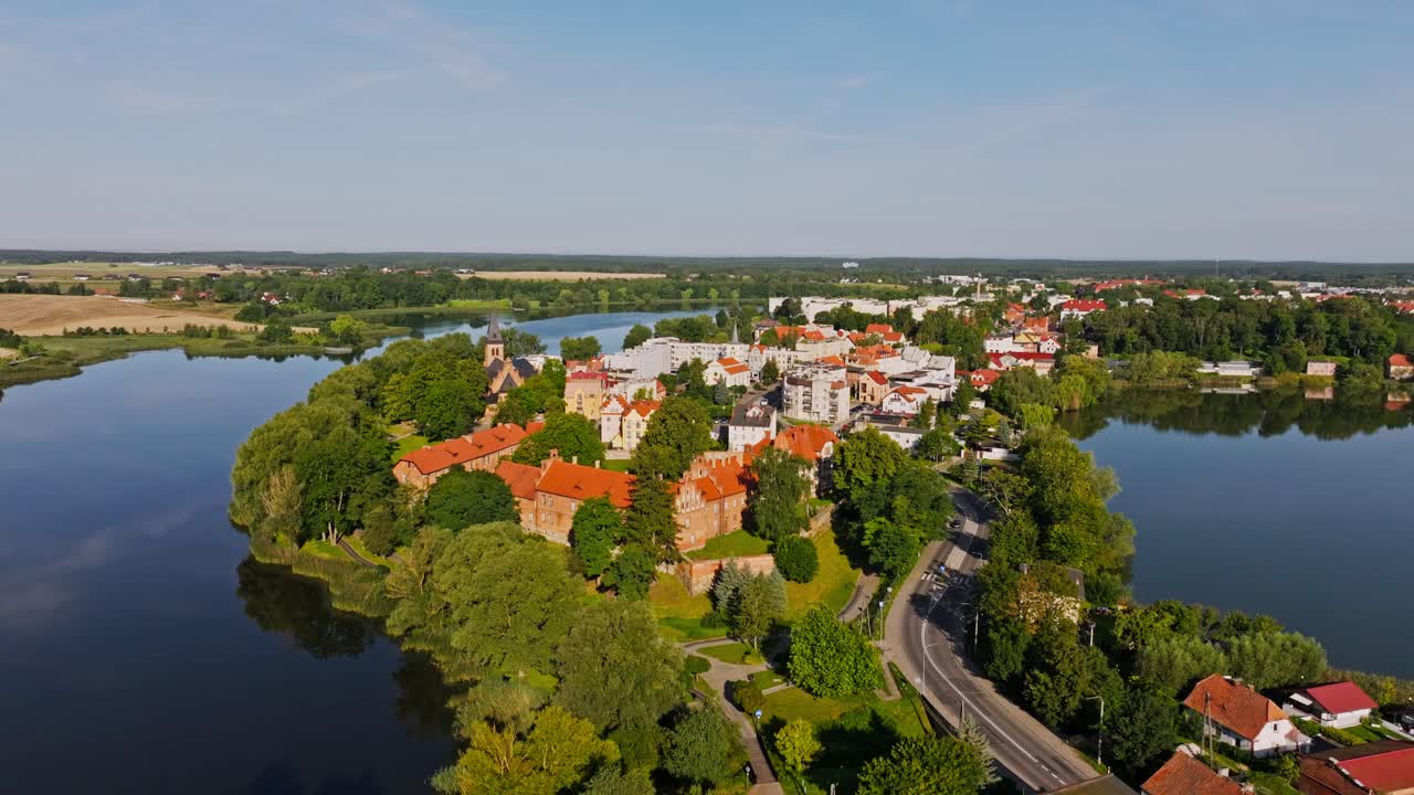 Low aerial shot of Sztum Castle and rooftops captured with forward drone motion
