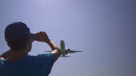 people are waving and cheering when a airplane s flying over them close for landing