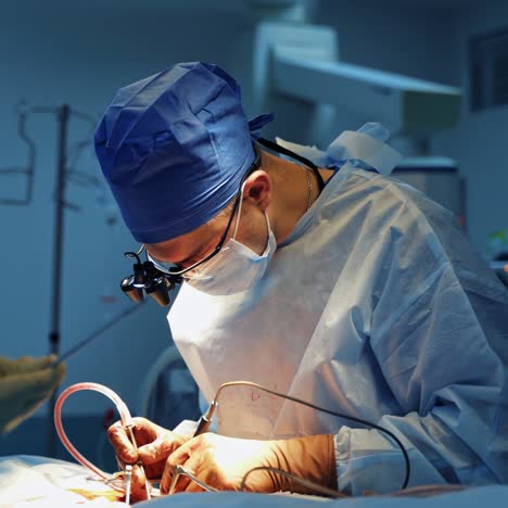 doctors perform surgery in clinic. medical specialist working with surgical tools during operation on a patient. male assistant helps the surgeon