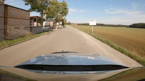 passing by a timber converting business at a rural summer landscape