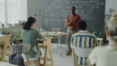 professor lecturing to students in a classroom