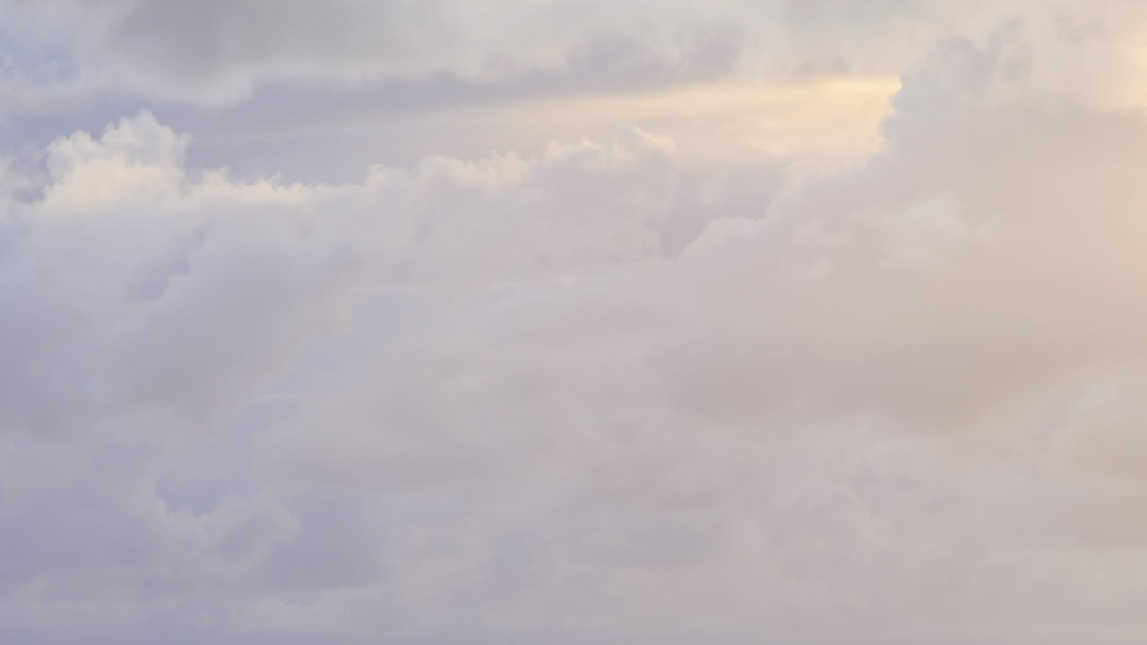 timelapse of clouds with blue, grey, white, yellow colours